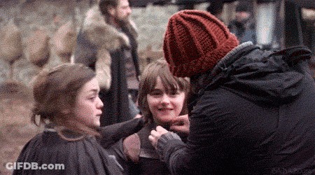 Man In Red Hat Talking To Two Girls On Movie Set GIF