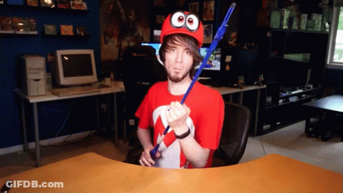 Man In Red Hat With Googly Eyes Holding Blue Stick GIF