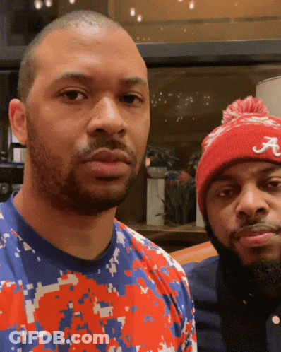 Man In Red Hat With Letter A Standing Next To Another Man GIF