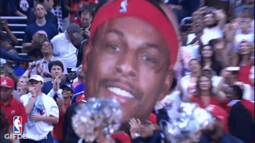 Man In Red Headband Holding Diamond In Front Of Crowd GIF