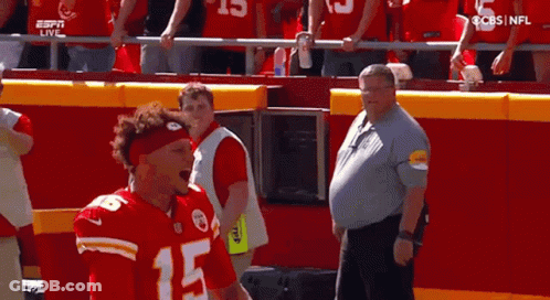 Man In Red Headband Standing Before Crowd GIF