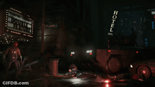 Man In Red Helmet And Leather Jacket Holding Two Guns GIF
