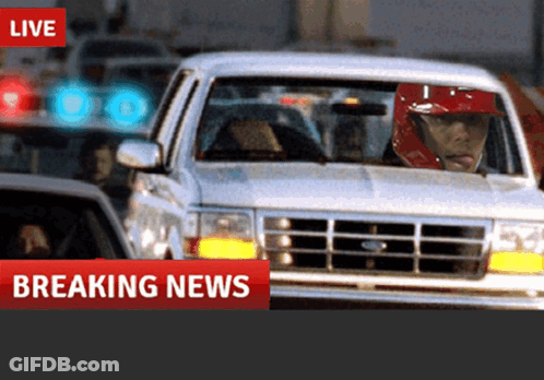 Man In Red Helmet Driving Car Breaking News GIF