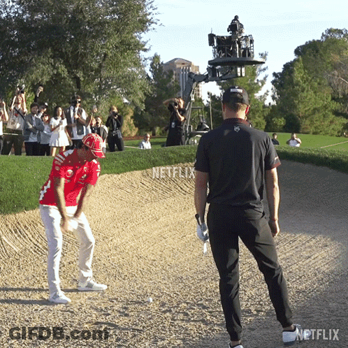Man In Red Hitting Golf Ball GIF