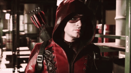 Man In Red Hooded Jacket Holding Red Arrow GIF