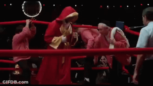 Man In Red Hoodie And Referee In Boxing Ring GIF