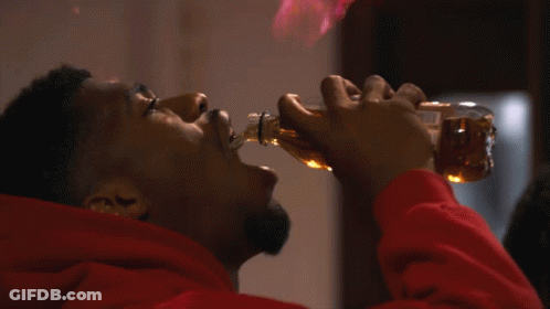 Man In Red Hoodie Drinking From Bottle With Flames GIF