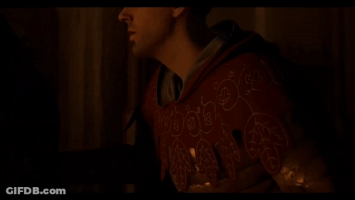 Man In Red Hoodie Holding Candle In Dark GIF