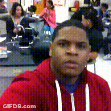 Man In Red Hoodie Looking At Camera In Front Of Group GIF