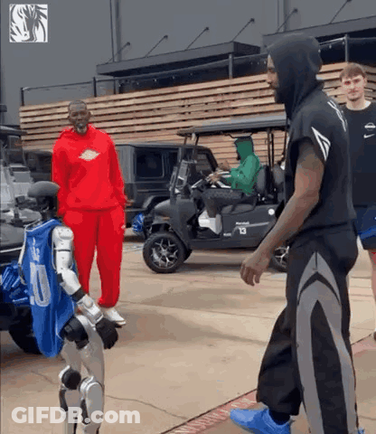 Man In Red Hoodie Next To Robot In Number 10 Jersey GIF