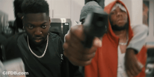 Man In Red Hoodie Pointing Gun At Another Man GIF