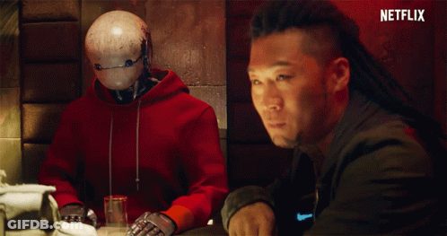 Man In Red Hoodie Talking To Robot GIF