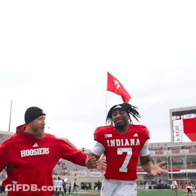 Man In Red Indiana Jersey Held By Another Man GIF