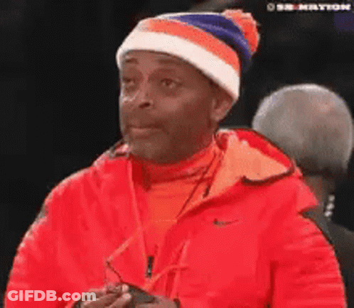 Man In Red Jacket And Beanie Looking GIF