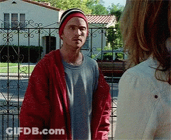 Man In Red Jacket And Beanie Next To Woman GIF