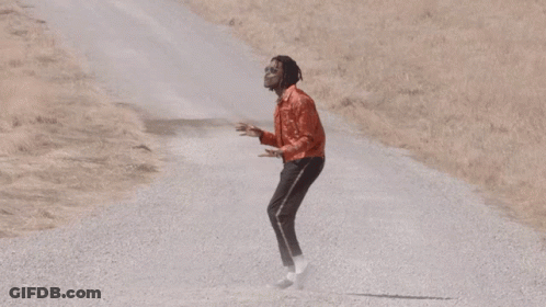 Man In Red Jacket And Black Pants On Gravel Road GIF