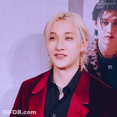 Man In Red Jacket And Black Shirt Smiling GIF
