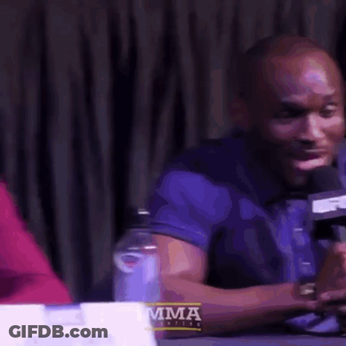 Man In Red Jacket And Tie At Desk GIF