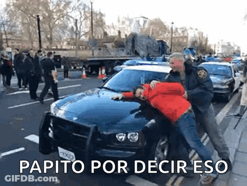 Man In Red Jacket Arrested By Police Officer In Front Of Car GIF