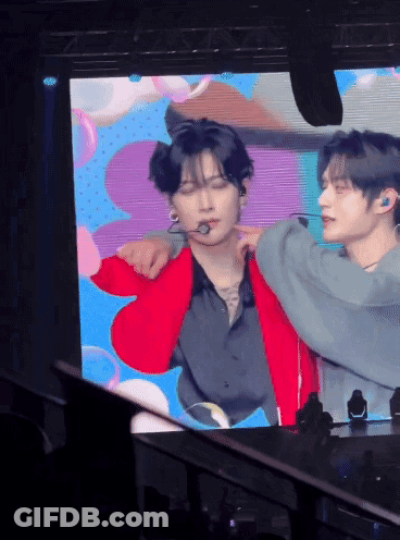 Man In Red Jacket Being Held By Another Man GIF