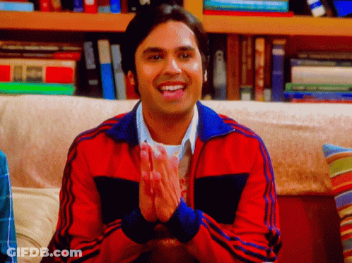 Man In Red Jacket Clapping Hands In Front Of Bookshelf GIF