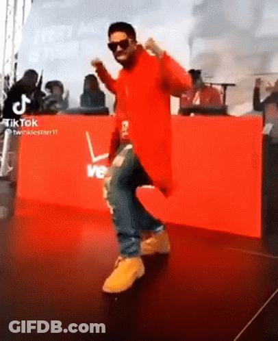 Man In Red Jacket Dancing At Verizon Sign GIF