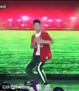 Man In Red Jacket Dancing In Green Field GIF