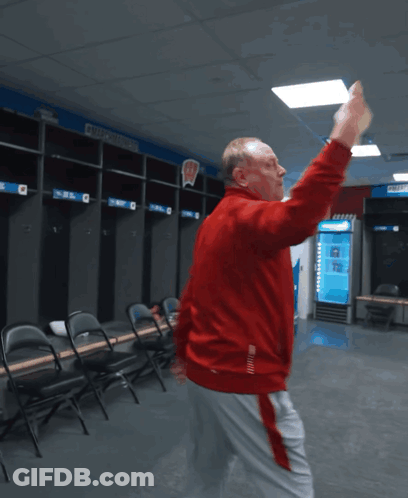 Man In Red Jacket Dancing In Locker Room With Number 2 GIF