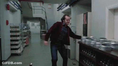 Man In Red Jacket Dancing Next To Film Reels GIF