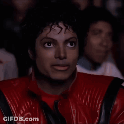 Man In Red Jacket Eating Popcorn In Theater GIF