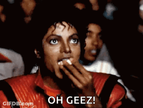 Man In Red Jacket Eating Popcorn Saying Oh Geez GIF
