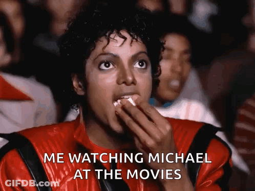Man In Red Jacket Eating Popcorn Says Me Watching Michael At The Movies GIF