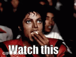 Man In Red Jacket Eating Popcorn Watching Movie GIF
