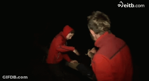 Man In Red Jacket Held By Person Eitb.com GIF