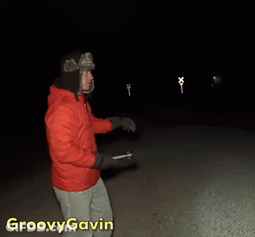 Man In Red Jacket Holding Flashlight Groovy Gavin GIF