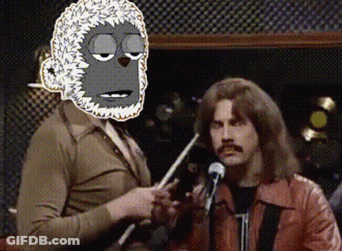 Man In Red Jacket Holding Microphone With Cartoon Monkey Behind GIF