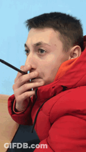 Man In Red Jacket Holding Phone To Nose GIF