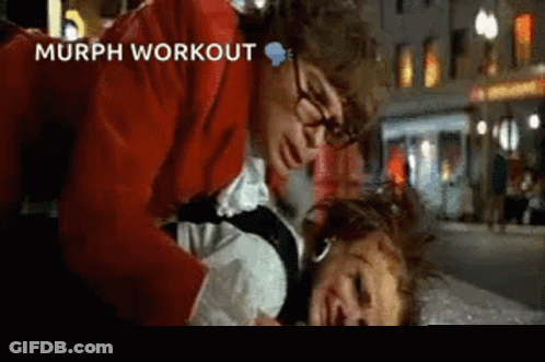 Man In Red Jacket Holding Woman In White Shirt On Ground GIF