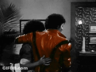 Man In Red Jacket Hugging Another Man In Black And White Photo GIF