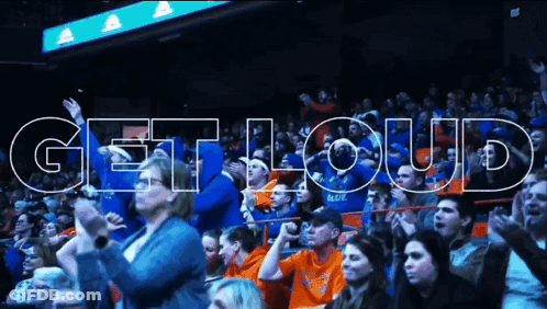 Man In Red Jacket In Front Of Crowd GIF