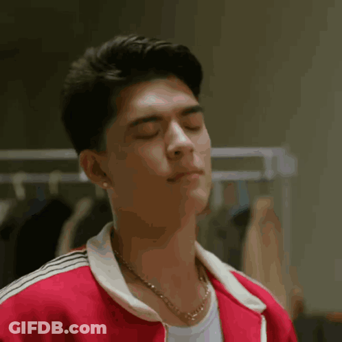 Man In Red Jacket Making Peace Sign GIF