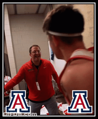 Man In Red Jacket Next To Man With Letter A GIF
