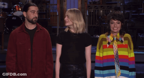 Man In Red Jacket Next To Two Women GIF
