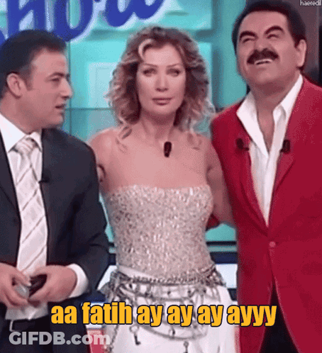 Man In Red Jacket Next To Woman In White Dress Saying Aa Fatih Ay Ay Ayy GIF