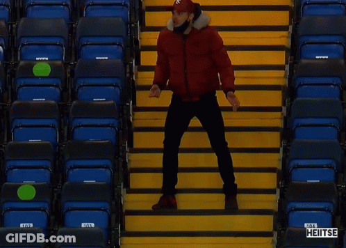 Man In Red Jacket On Stadium Stairs With Heitse GIF