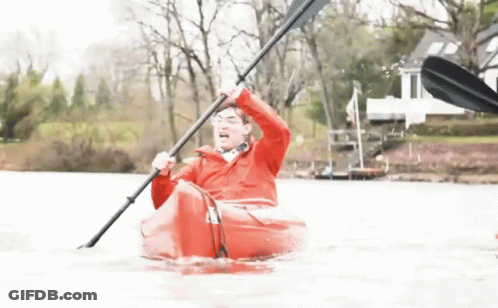 Man In Red Jacket Paddling Red Kayak In Lake GIF
