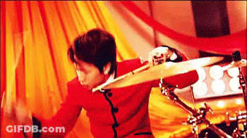 Man In Red Jacket Playing Drum Set GIF