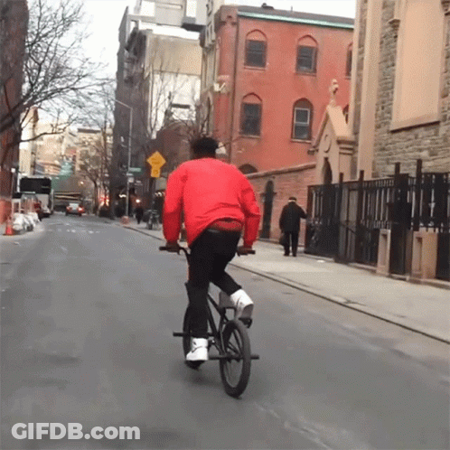 Man In Red Jacket Riding Bike GIF