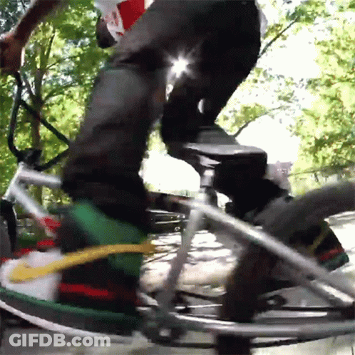 Man In Red Jacket Riding Bike Next To Fire Hydrant GIF
