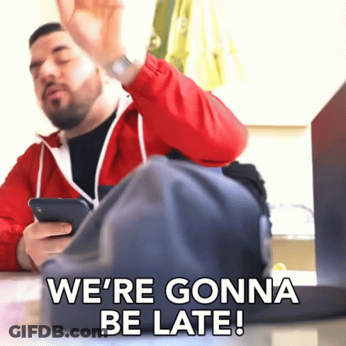 Man In Red Jacket Saying We're Gonna Be Late Holding Cell Phone GIF